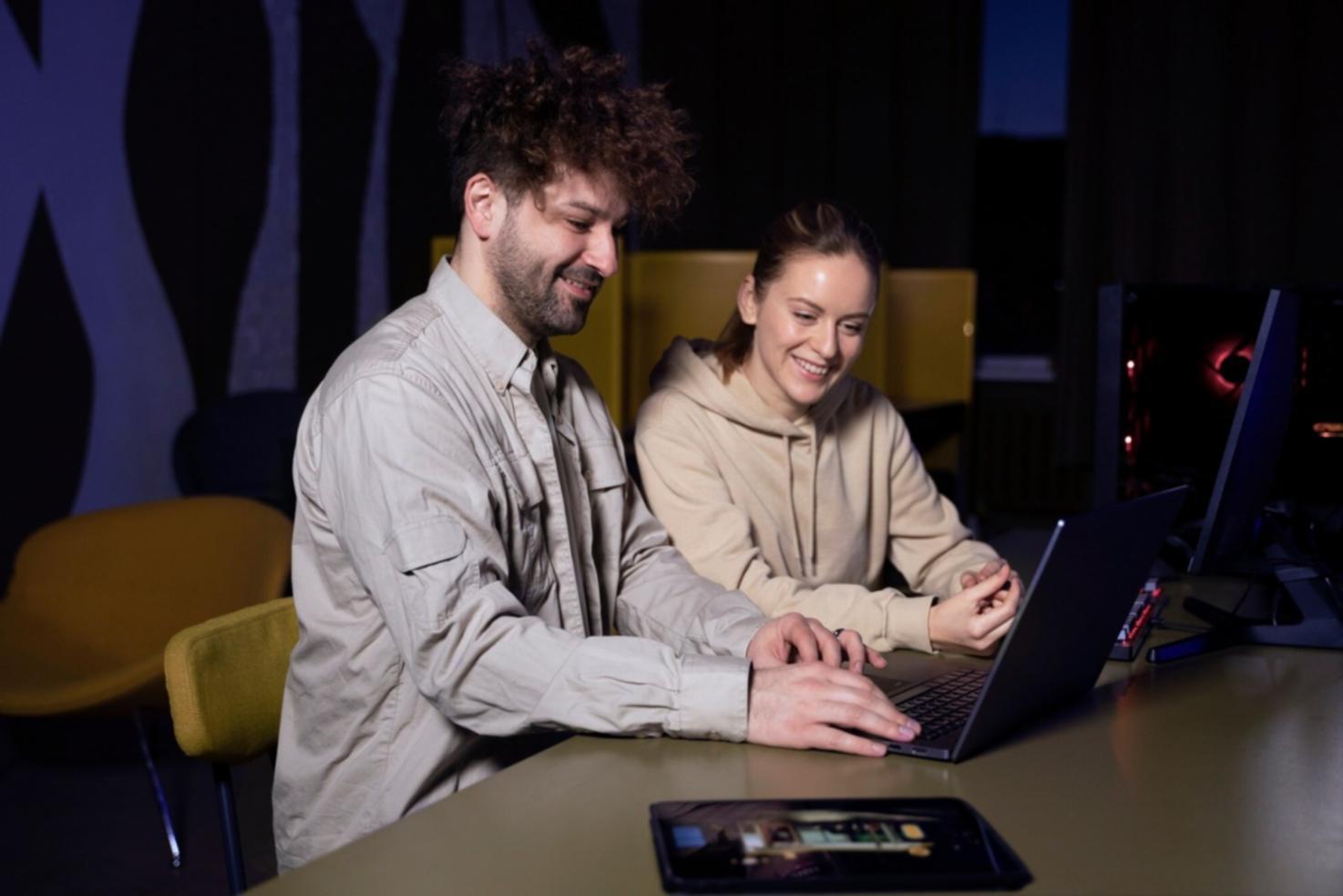 Students working on mobile testing projects with physical devices